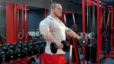 肌肉健美运动员在健身房用哑铃做运动